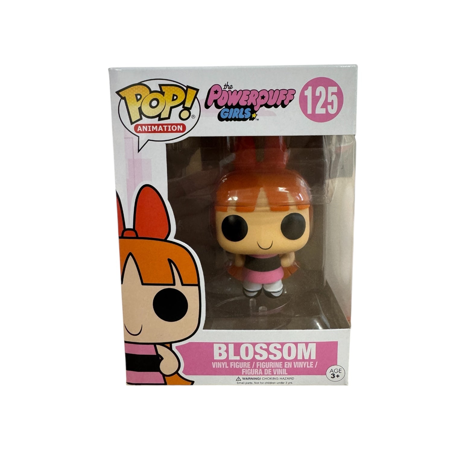 Blossom standing with her famous pink and black dress and red bow.